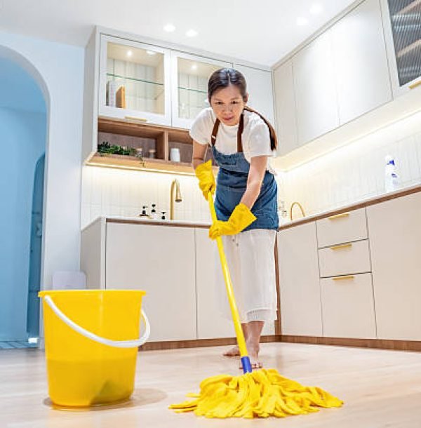 Barefoot woman cleaning kitchen floor with wet mop pad House Cleaning Umm Al Quwain